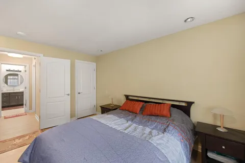 a bedroom with a bed and a tv on the dresser