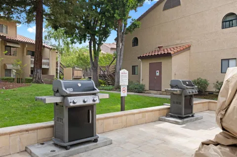 a backyard of a house with table and chairs