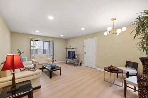 a living room with furniture a lamp and a window