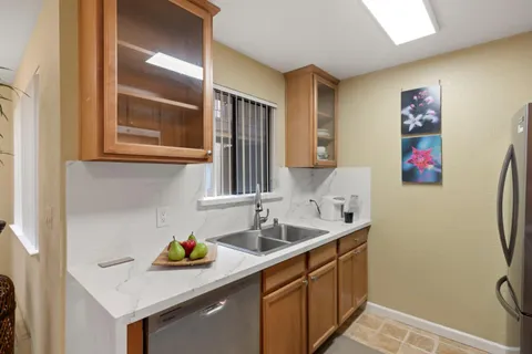 a kitchen with a sink and a refrigerator