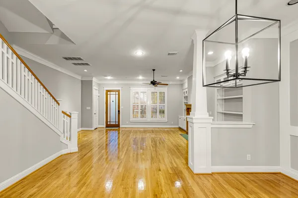 a view of a room with wooden floor and staircase
