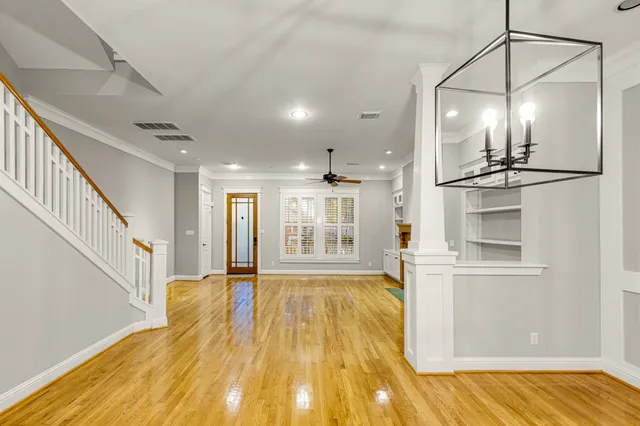 a view of a room with wooden floor and staircase
