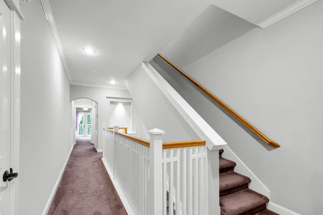 a view of a hallway with entryway and stairs