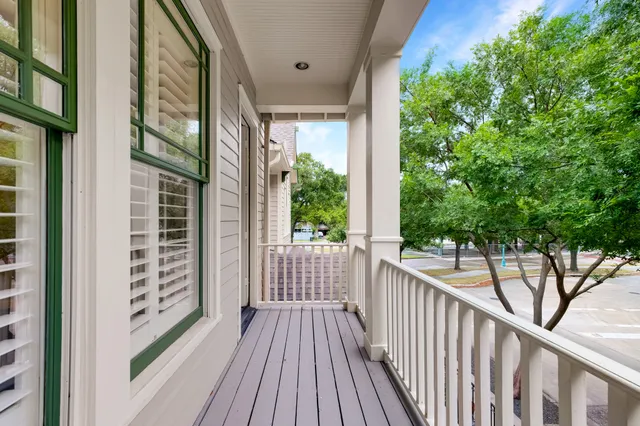 a view of a balcony with wooden floor