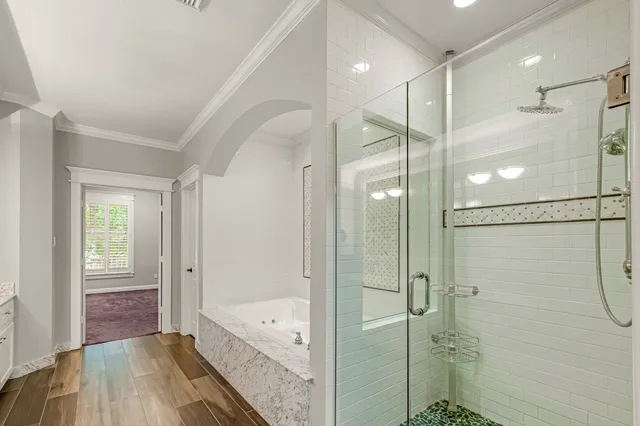 a bathroom with a glass shower door and a sink