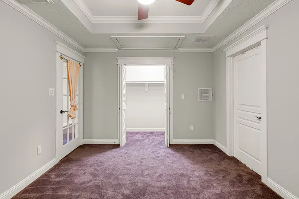 an empty room that has a grey walls