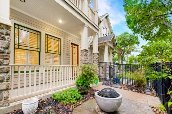 a view of a balcony with large trees and plants