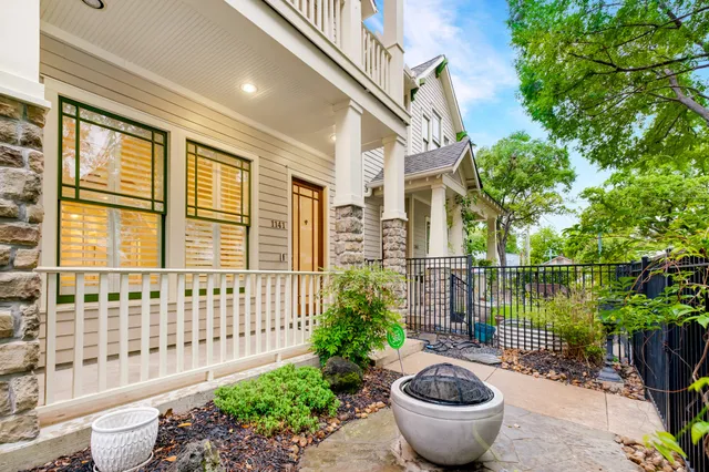 a view of a balcony with large trees and plants