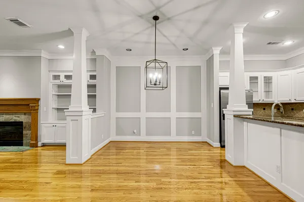 a view of empty room with wooden floor and fireplace