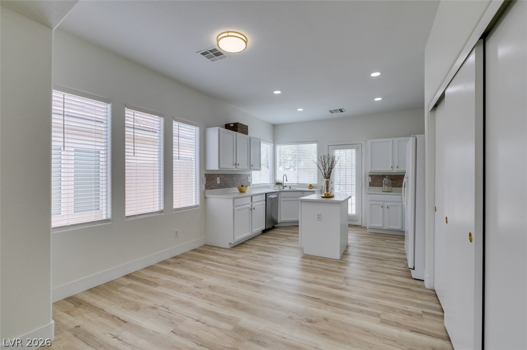 10959 Pumpkin Ridge Avenue Las Vegas, NV 89135 - Photo 10 of 51 Well-lit kitchen with sleek white cabinetry offers functional elegance.
