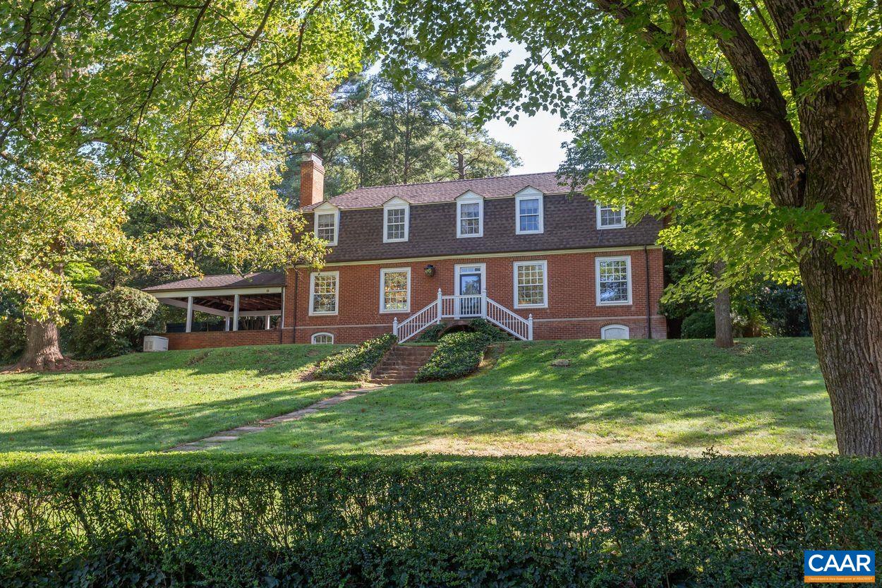 1310 Blue Ridge Road Charlottesville, VA 22903 - Photo 3 of 50 a brick house with a big yard and large trees