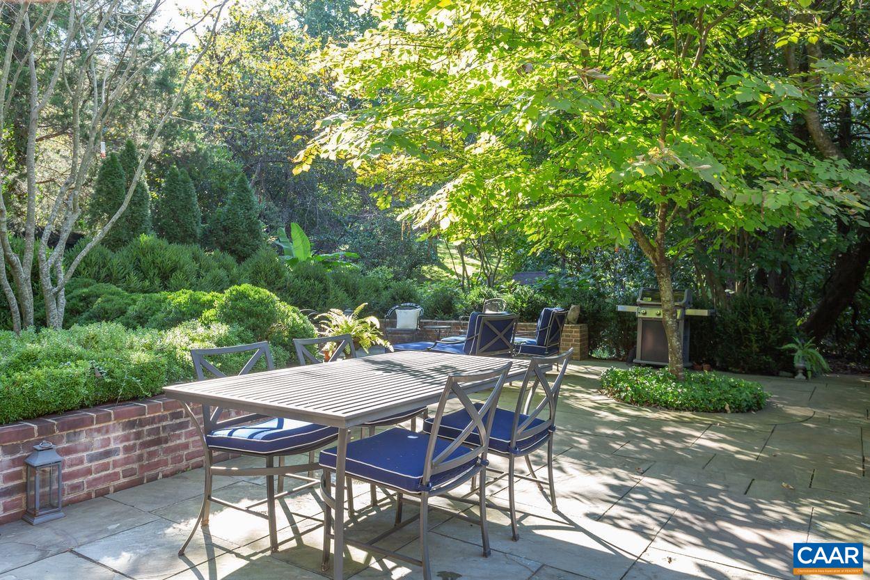 1310 Blue Ridge Road Charlottesville, VA 22903 - Photo 34 of 50 a view of a patio with table and chairs and a large tree