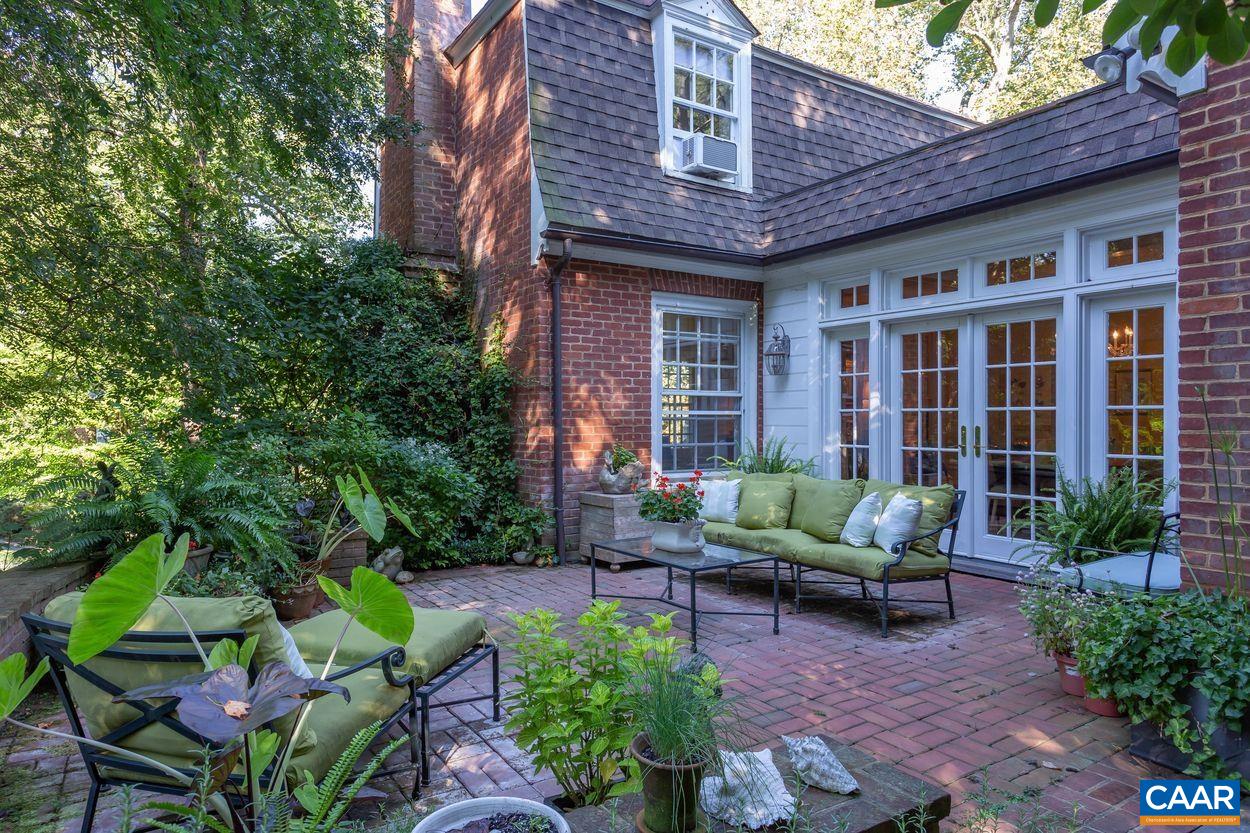 1310 Blue Ridge Road Charlottesville, VA 22903 - Photo 37 of 50 a view of a patio with couches table and chairs potted plants and large tree