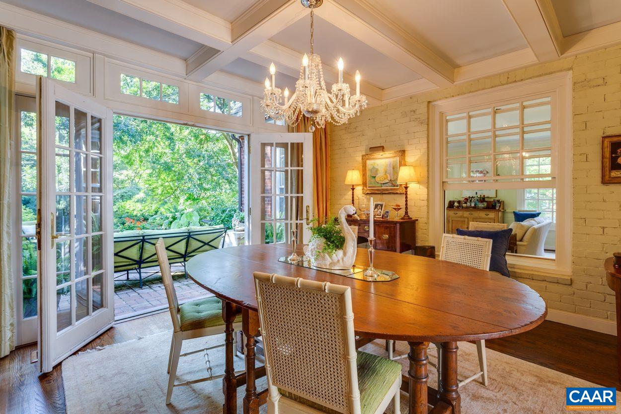 1310 Blue Ridge Road Charlottesville, VA 22903 - Photo 8 of 50 a dining room with furniture a chandelier and wooden floor