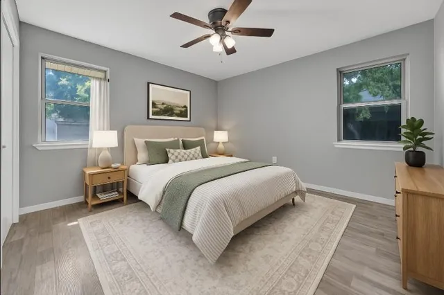 a bedroom with a bed and a chandelier