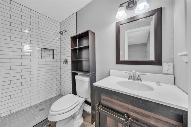 a bathroom with a toilet sink and mirror