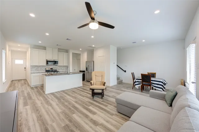 a living room with furniture and kitchen view