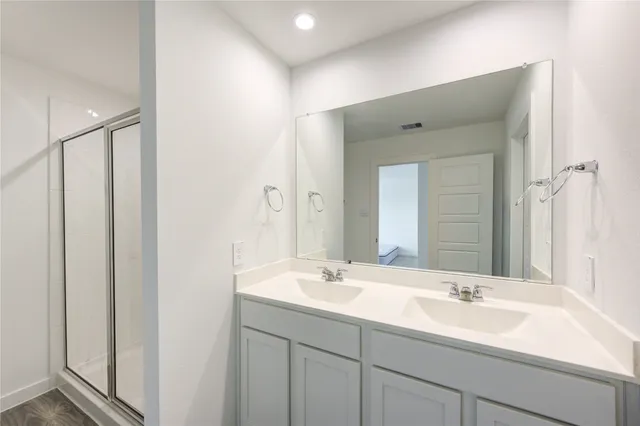 a bathroom with 2 sink and a mirror