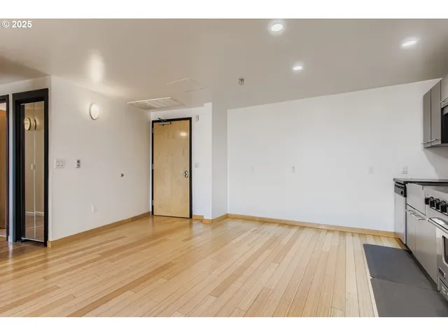 a kitchen with stainless steel appliances a refrigerator and a stove top oven