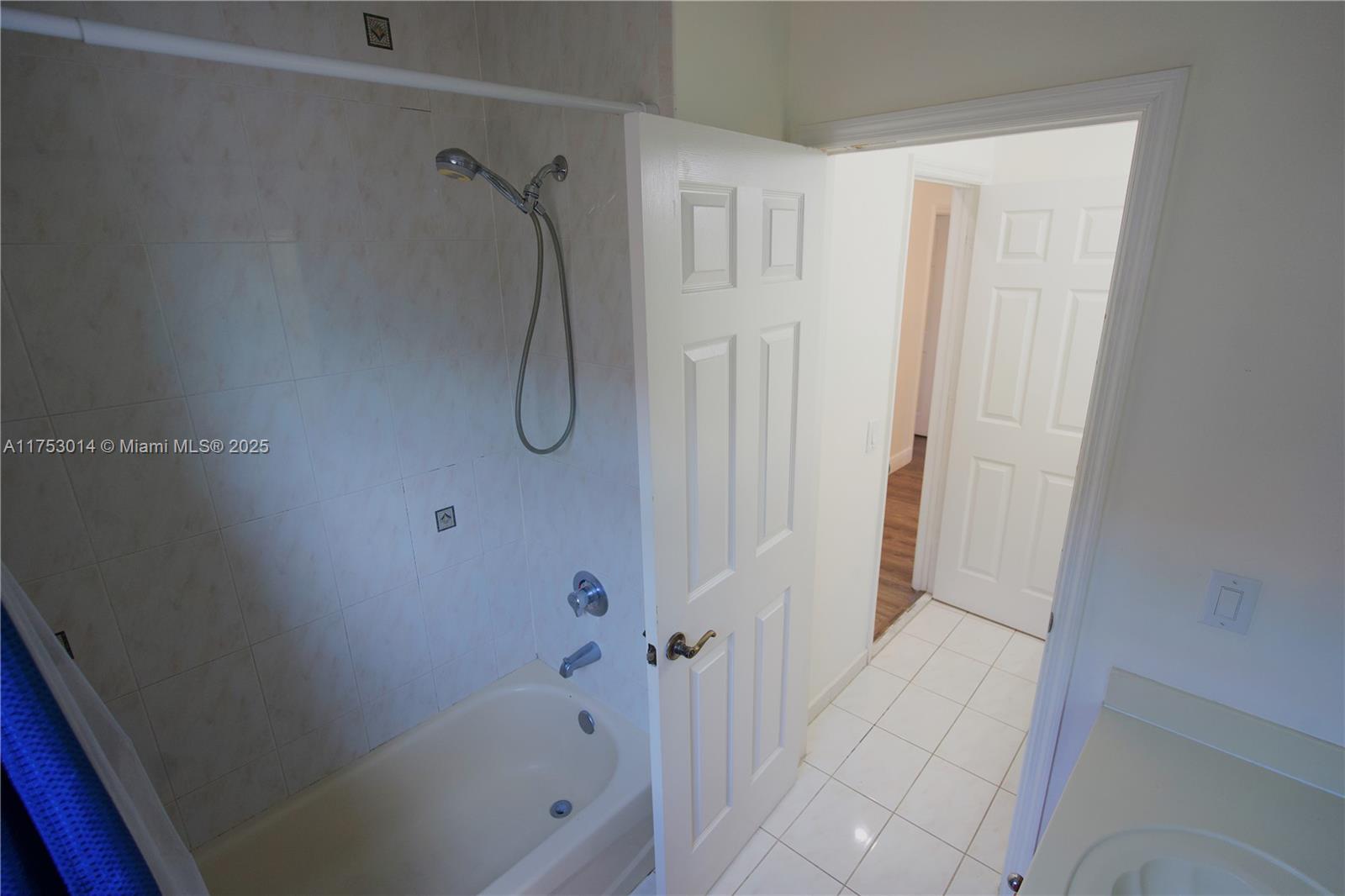 2631 Southwest 153rd Path, Unit 2631 Miami, FL 33185 - Photo 20 of 29 a bathroom with a glass shower door