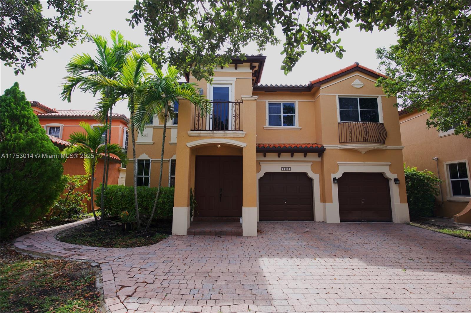 2631 Southwest 153rd Path, Unit 2631 Miami, FL 33185 - Photo 2 of 29 a front view of a house with a yard and a garage