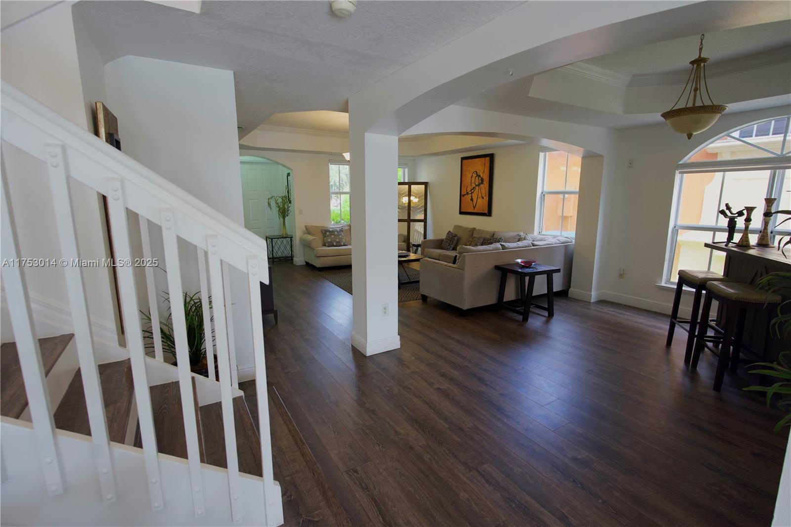 2631 Southwest 153rd Path, Unit 2631 Miami, FL 33185 - Photo 6 of 29 a living room with couches chairs and couches with wooden floor
