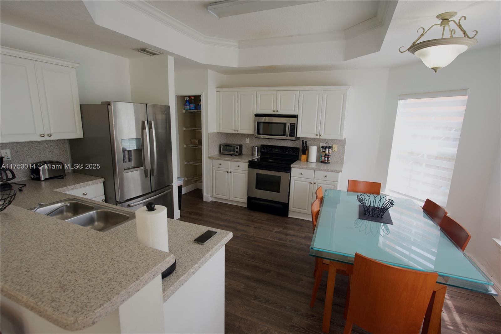 2631 Southwest 153rd Path, Unit 2631 Miami, FL 33185 - Photo 9 of 29 a kitchen with a refrigerator sink and microwave