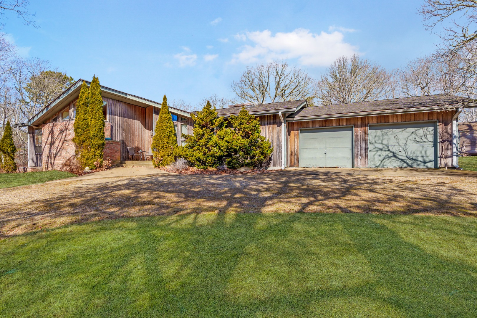 21 Llewellyn Way Edgartown, MA 02539 - Photo 1 of 34 a front view of a house with a yard and garage