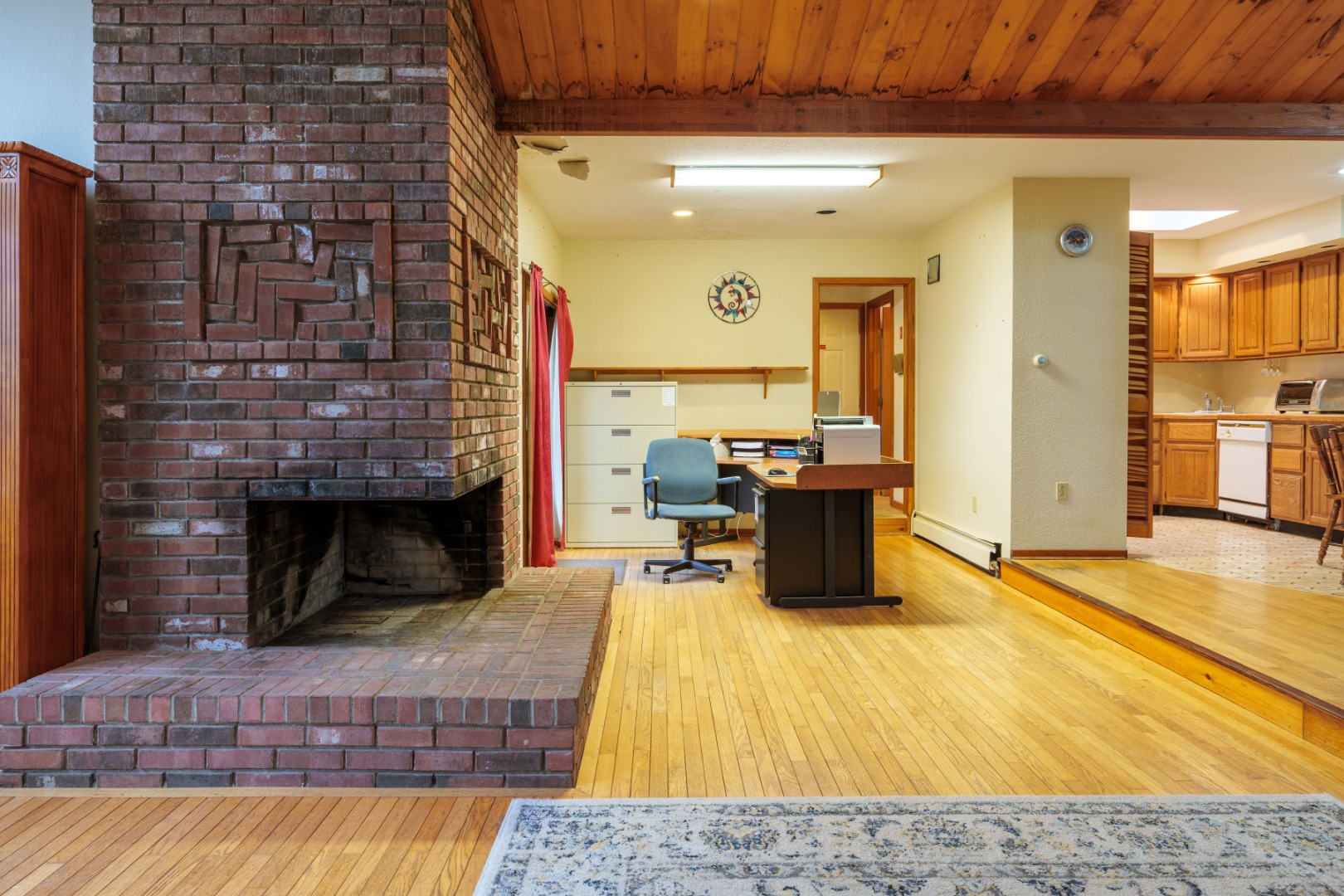 21 Llewellyn Way Edgartown, MA 02539 - Photo 12 of 34 a living room with a fireplace and kitchen view