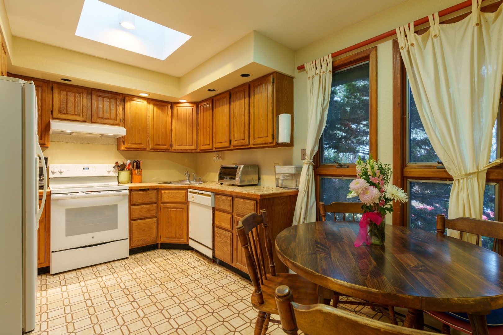 21 Llewellyn Way Edgartown, MA 02539 - Photo 7 of 34 a kitchen with sink cabinets and outdoor view