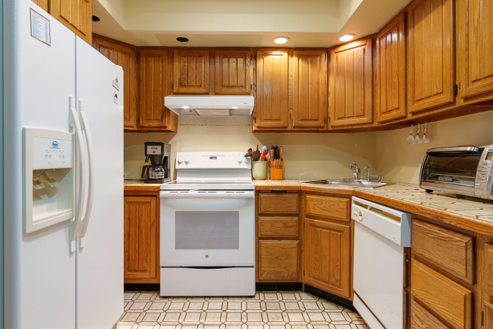 21 Llewellyn Way Edgartown, MA 02539 - Photo 8 of 34 a kitchen with a refrigerator sink and cabinets