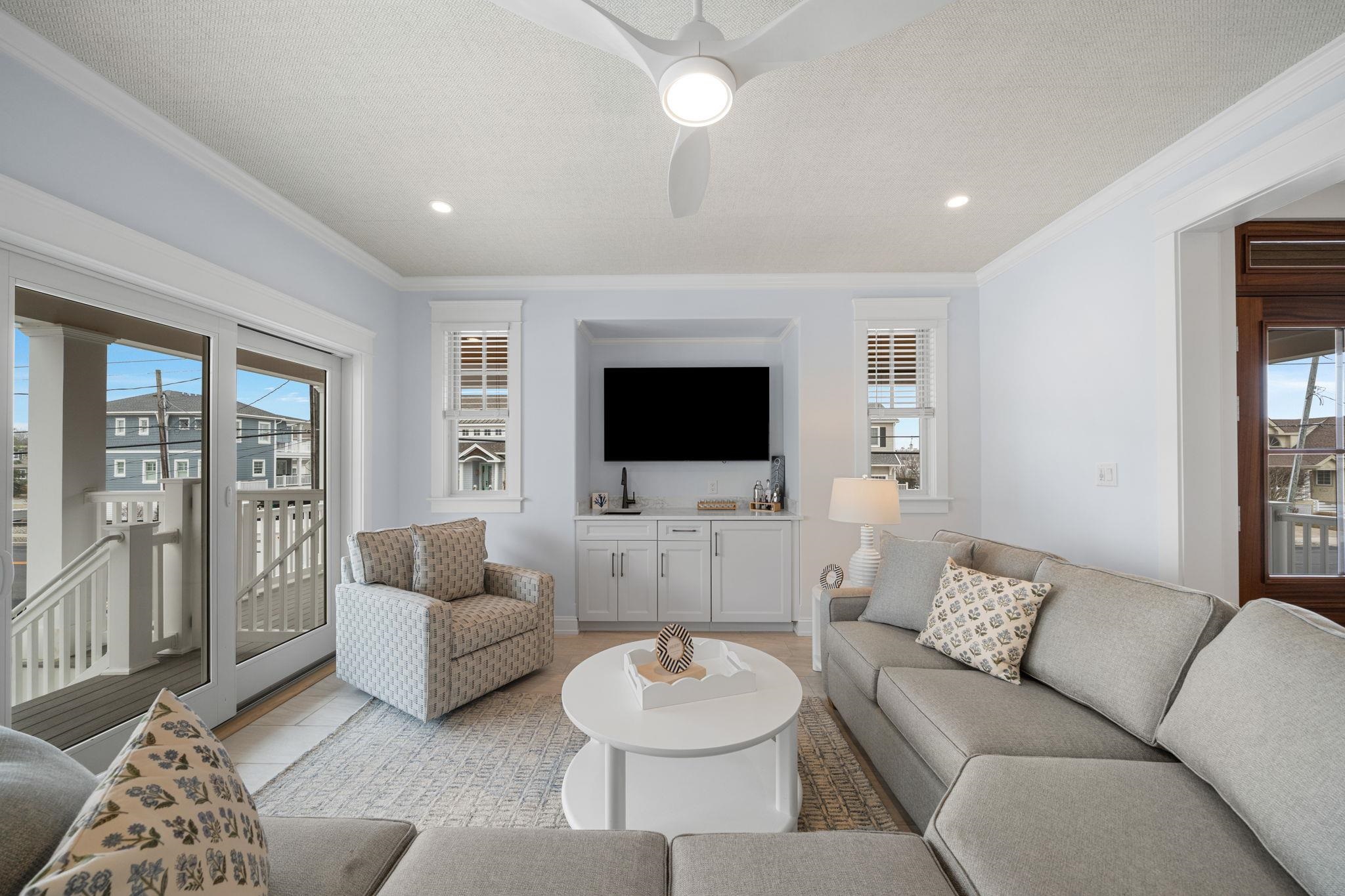 9102 3rd Stone Harbor, NJ 08247 - Photo 16 of 24 a living room with furniture and a flat screen tv