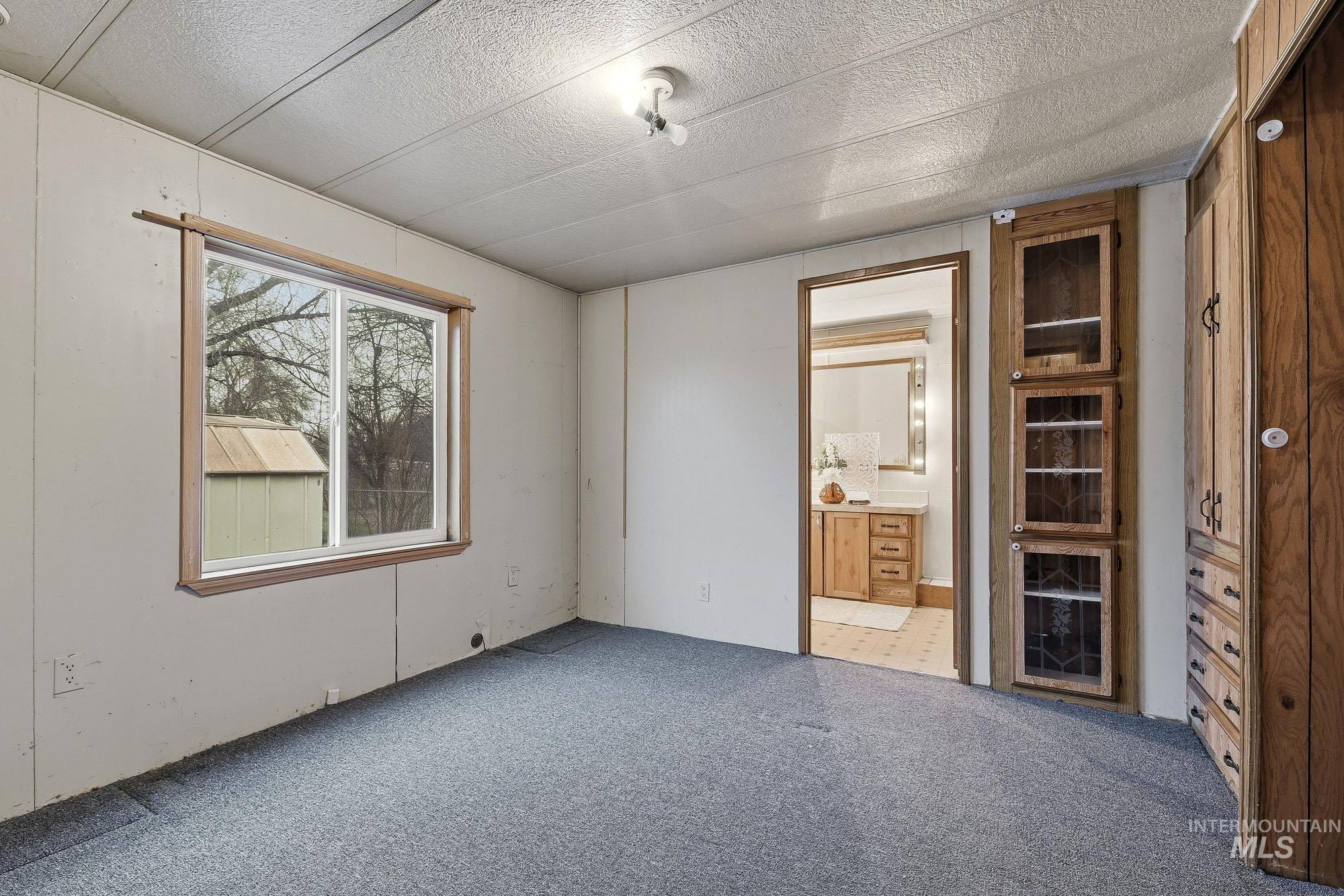 5200 Midway, Unit TRIR 20 Caldwell, ID 83607 - Photo 16 of 31 Unfurnished bedroom with carpet flooring and ensuite bathroom