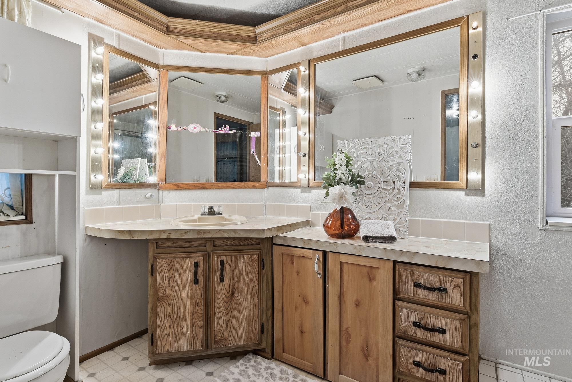 5200 Midway, Unit TRIR 20 Caldwell, ID 83607 - Photo 18 of 31 Bathroom featuring a textured wall, vanity, and light flooring