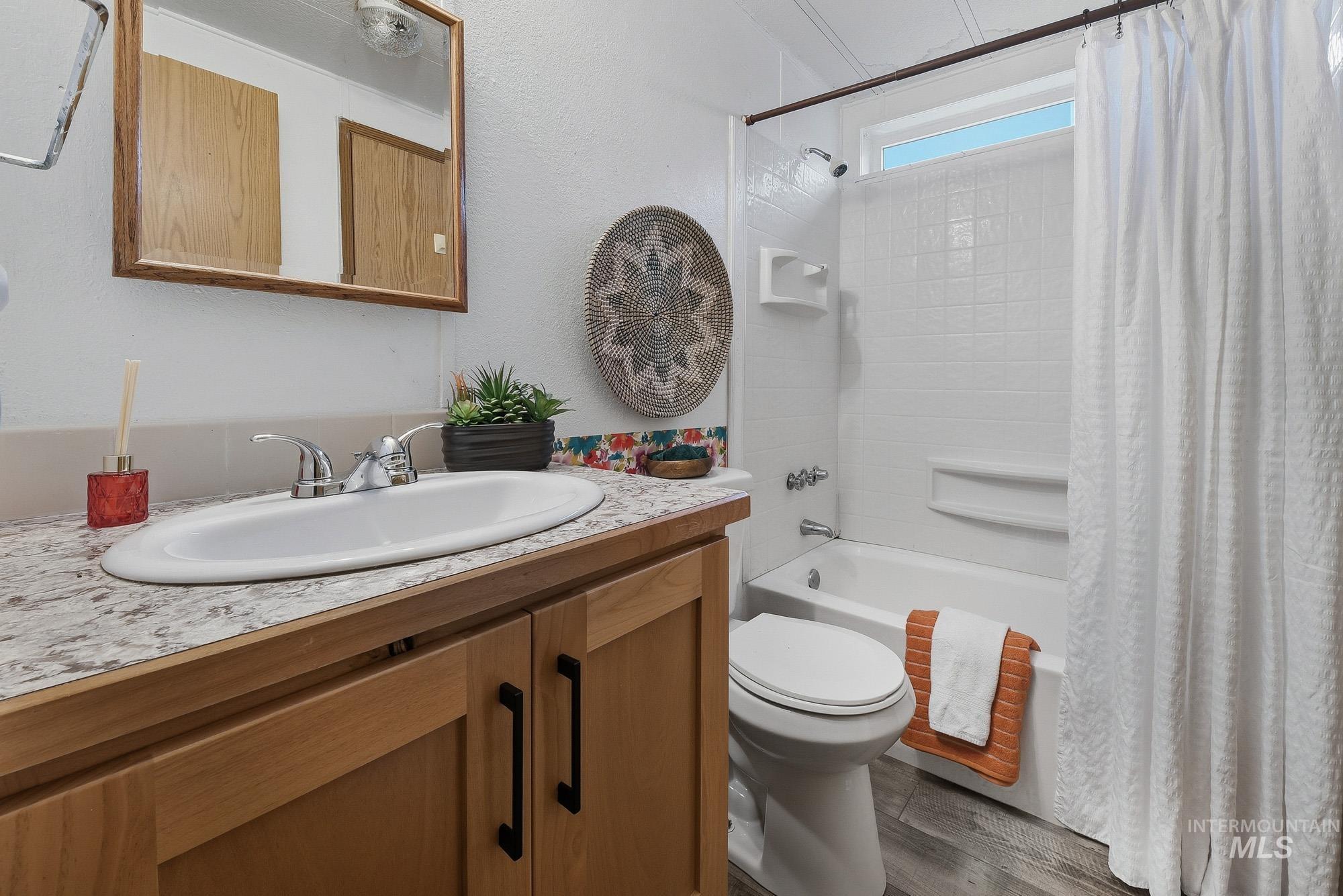 5200 Midway, Unit TRIR 20 Caldwell, ID 83607 - Photo 28 of 31 Bathroom with shower / bath combo, vanity, and dark wood-style floors