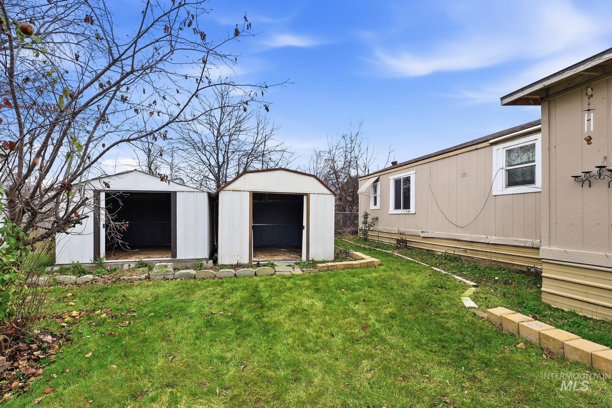 5200 Midway, Unit TRIR 20 Caldwell, ID 83607 - Photo 30 of 31 View of green lawn with a storage unit