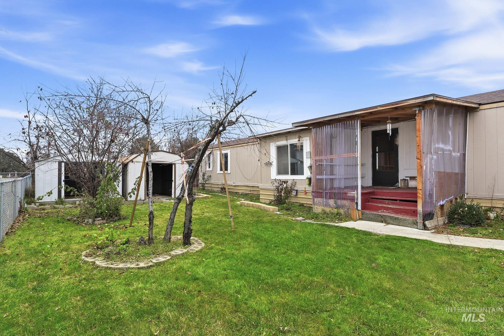 5200 Midway, Unit TRIR 20 Caldwell, ID 83607 - Photo 5 of 31 View of grassy yard with a storage shed