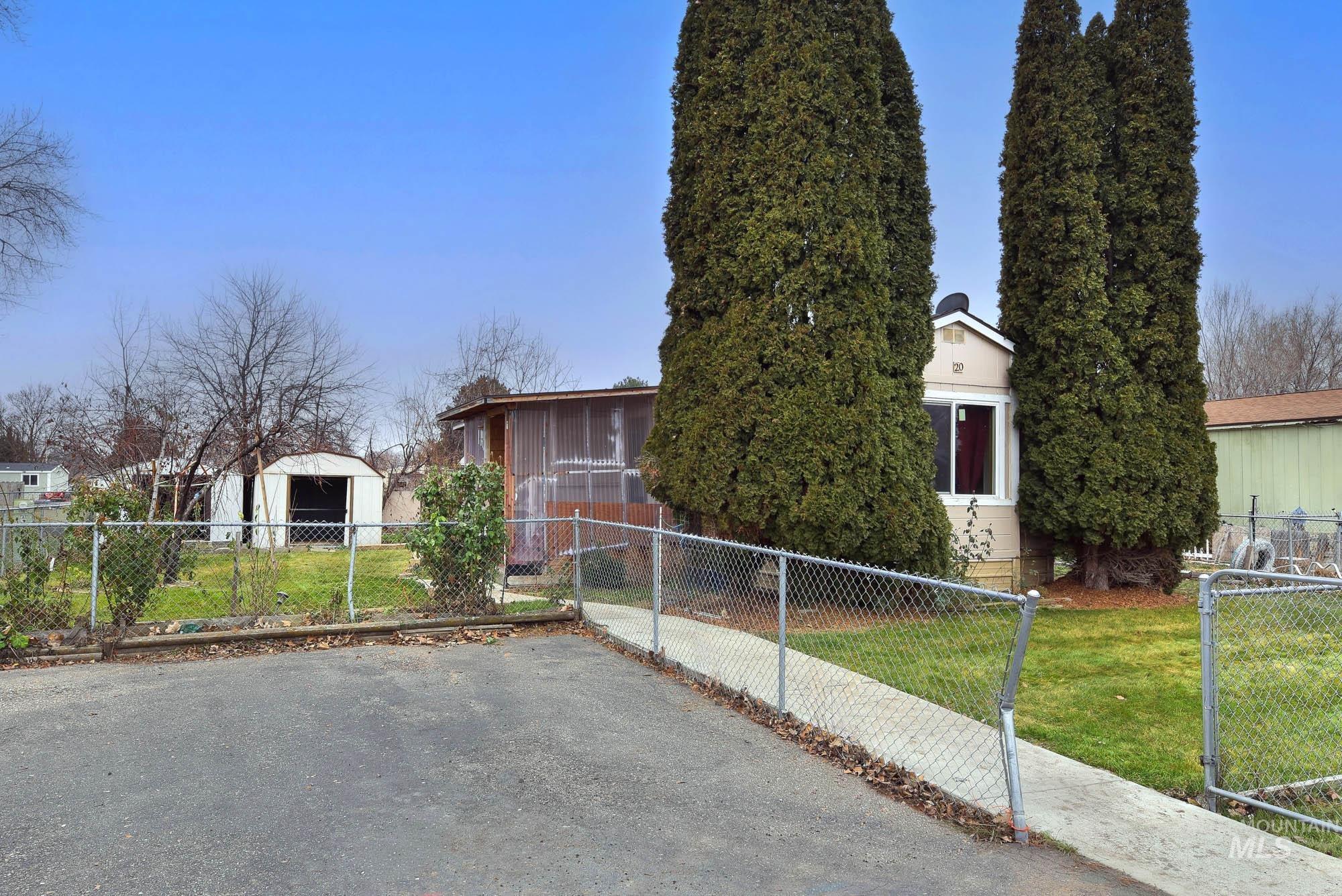 5200 Midway, Unit TRIR 20 Caldwell, ID 83607 - Photo 6 of 31 View of side of property with a fenced front yard and a gate