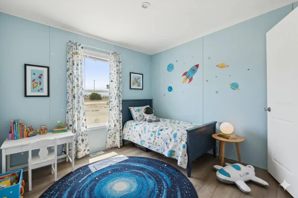 a bedroom with a bed and a window