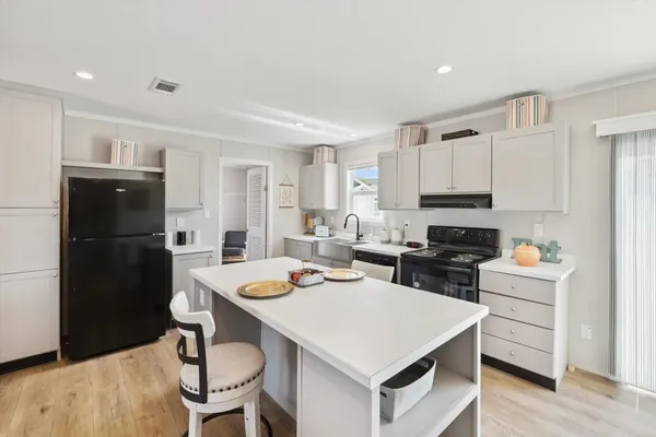 a kitchen that has a table and chairs in it