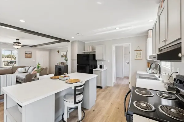a large kitchen with a table and chairs