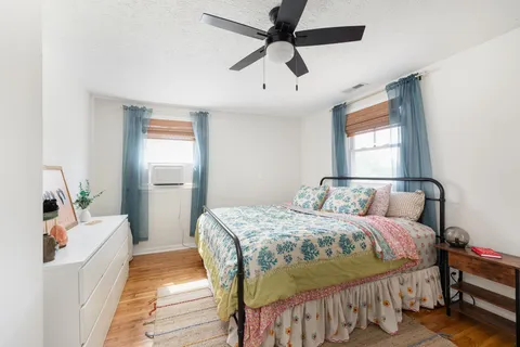 a bedroom with a bed and a mirror