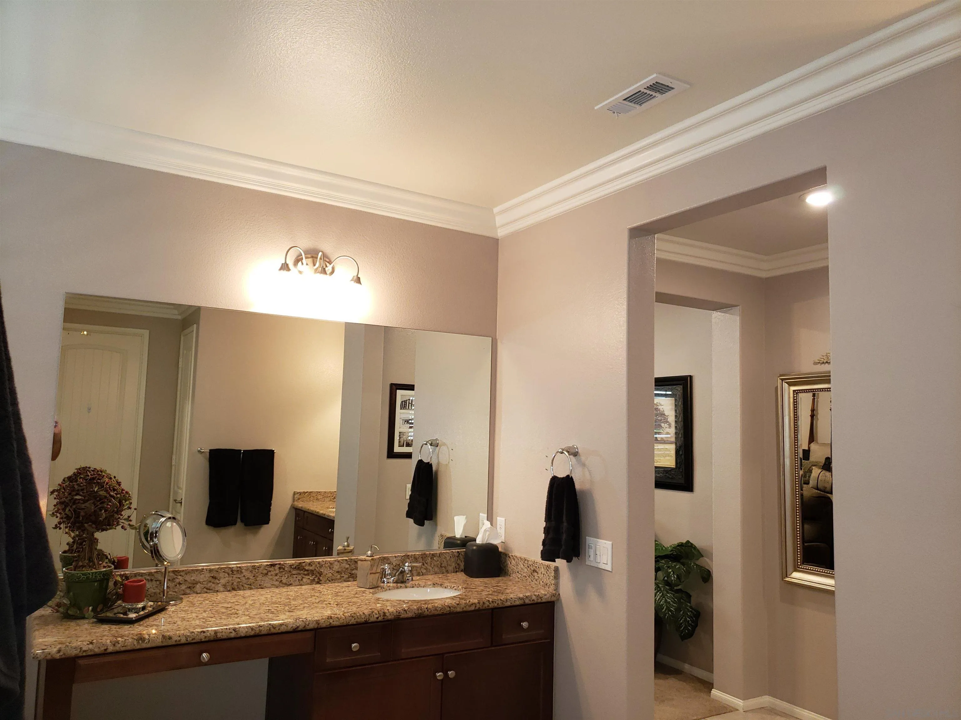 1624 Paseo Diamonte Hemet, CA 92545 - Photo 18 of 35 a bathroom with a granite countertop sink and a mirror
