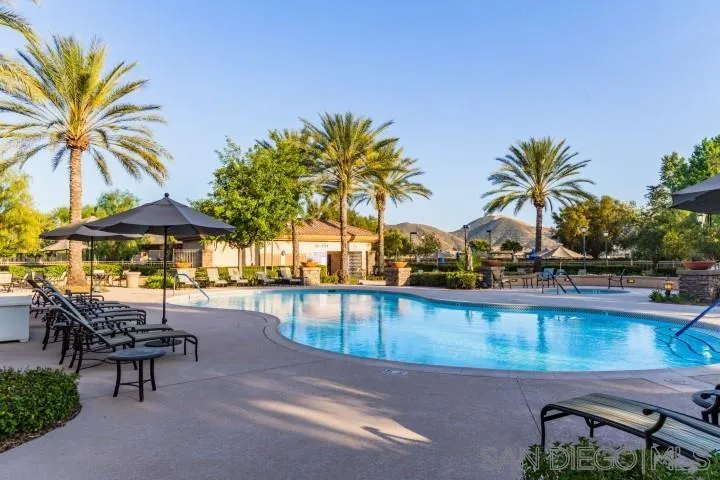 1624 Paseo Diamonte Hemet, CA 92545 - Photo 33 of 35 a view of a swimming pool with a table and chairs under an umbrella