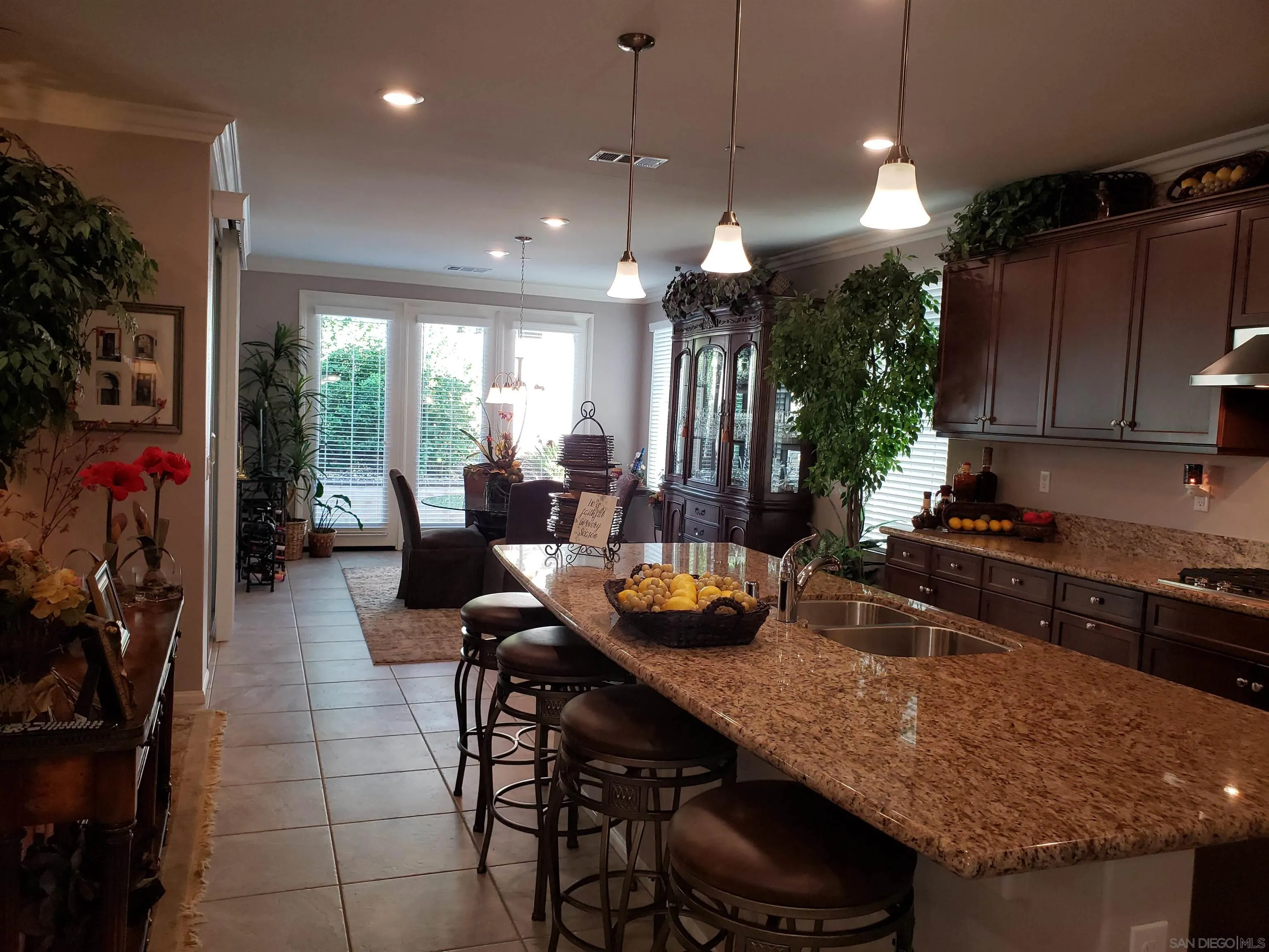 1624 Paseo Diamonte Hemet, CA 92545 - Photo 6 of 35 a kitchen with a table chairs sink and cabinets