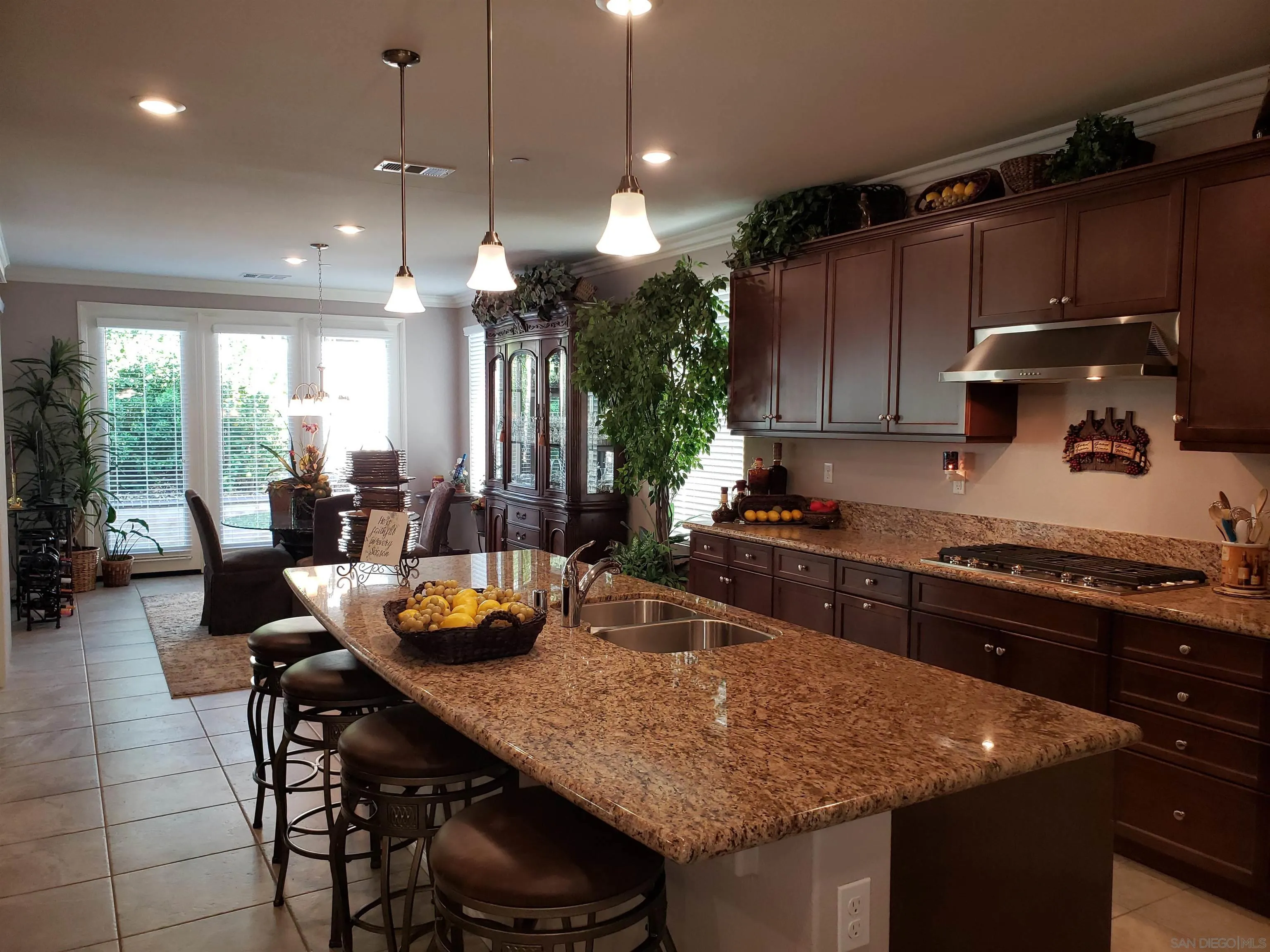 1624 Paseo Diamonte Hemet, CA 92545 - Photo 7 of 35 a kitchen with a table chairs sink and cabinets