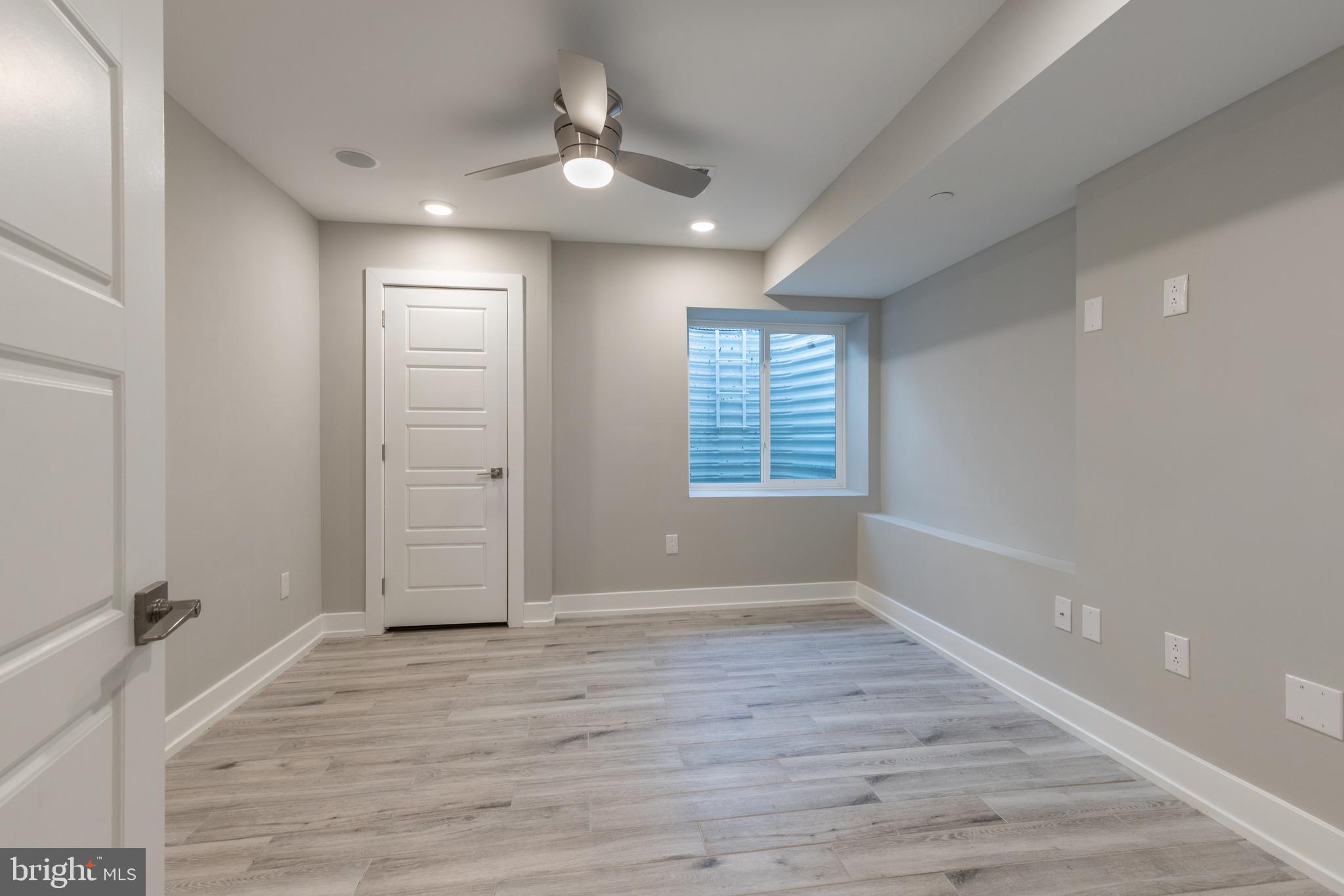 141 West Huntingdon Street, Unit 1 Philadelphia, PA 19133 - Photo 9 of 21 wooden floor in an empty room with a window