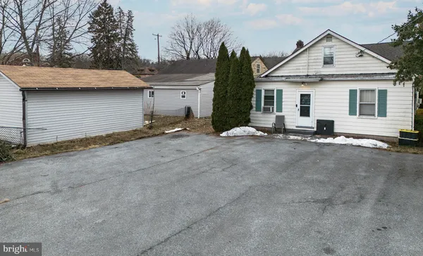 a view of a house with a yard and garage