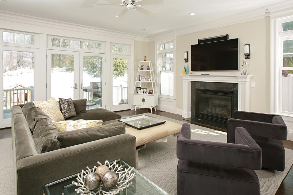 25 Marthas Lane Brookline, MA 02467 - Photo 3 of 10 a living room with furniture a fireplace and a flat screen tv