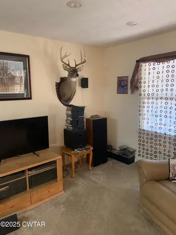 a living room with furniture ceiling fan and a window